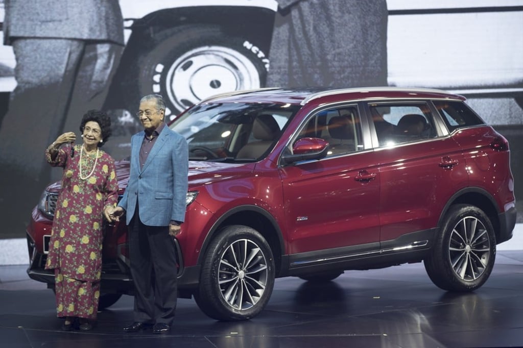 Malaysia Prime Minister Mahathir Mohamad (right) in a selfie with his wife Siti Hasmah during the launch of Proton’s X70 SUV in Kuala Lumpur on December 12, 2018. Geely, which owns 49.9 per cent of Proton, helped launch the Malaysian brand’s first sports utility vehicle. Photo: AP