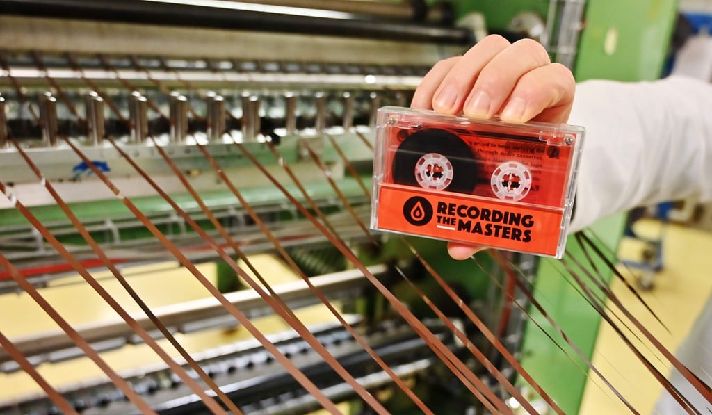 A man holds an audio cassette made with magnetic stripes in the Mulann. Photo: AFP