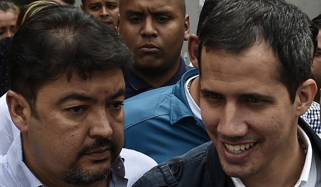 Venezuelan opposition leader and self-declared acting president Juan Guaido (right), greets supporters, next to his chief of staff Roberto Marrero. Photo: AFP Venezuelan opposition leader and self-declared acting president Juan Guaido (right), greets supporters, next to his chief of staff Roberto Marrero. Photo: AFP