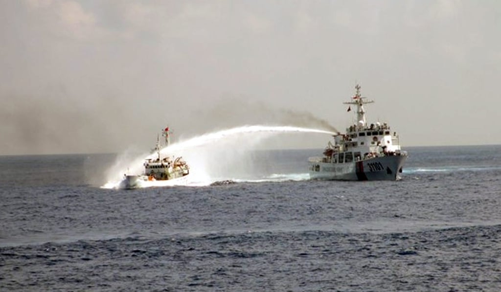 A May 2014 file photo shows a Chinese vessel using water cannons on a Vietnamese boat. Photo: EPA