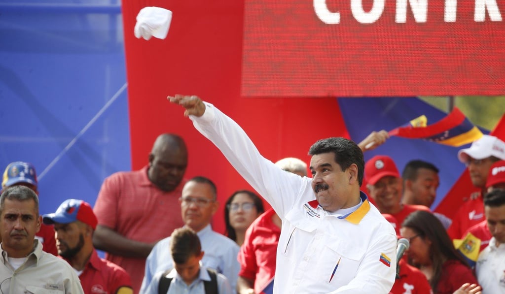Venezuela’s President Nicolas Maduro throws his handkerchief into a crowd of supporters. Photo: AP Photo Venezuela’s President Nicolas Maduro throws his handkerchief into a crowd of supporters. Photo: AP Photo