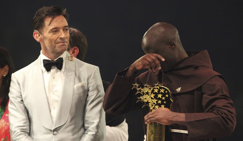 Kenyan teacher Peter Tabichi reacts as actor Hugh Jackman, watches after the teacher won the $1 million Global Teacher Prize in Dubai. Photo: AP Photo Kenyan teacher Peter Tabichi reacts as actor Hugh Jackman, watches after the teacher won the $1 million Global Teacher Prize in Dubai. Photo: AP Photo