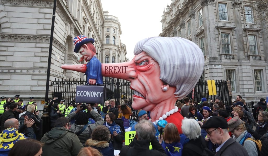 A puppet head of Britain's Prime Minister Theresa May spearing a representation of the British Economy is positioned on Whitehall outside Downing Street. Photo: AFP