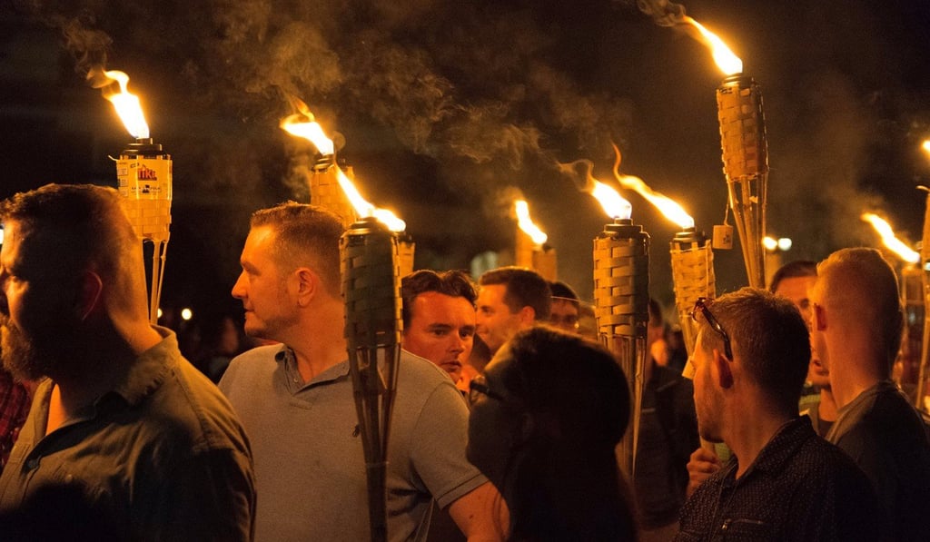 White nationalists carry torches on the grounds of the University of Virginia, before a planned Unite The Right rally in Charlottesville in August 2017. Photo: Alejandro Alvarez/News2Share