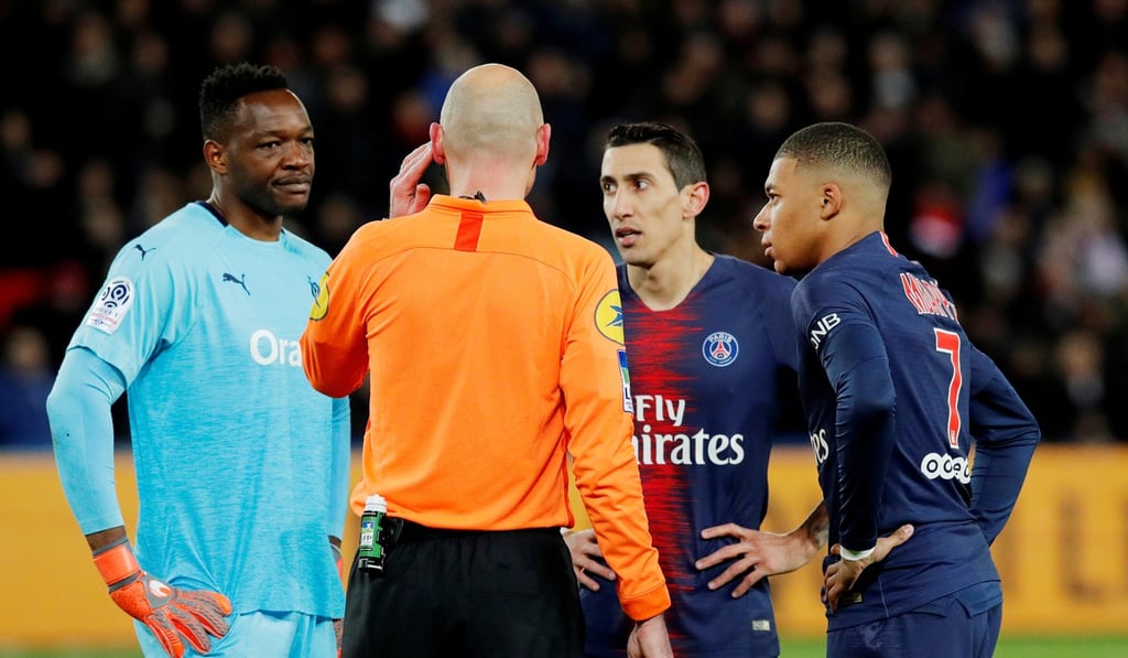 Paris Saint-Germain’s Angel Di Maria, Kylian Mbappe and Marseille’s Steve Mandanda look on as referee consults VAR. Photo: Reuters