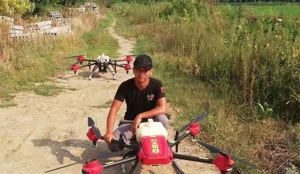 Zhu Beibei posing with his drones in a farmer's field. Photo: Handout