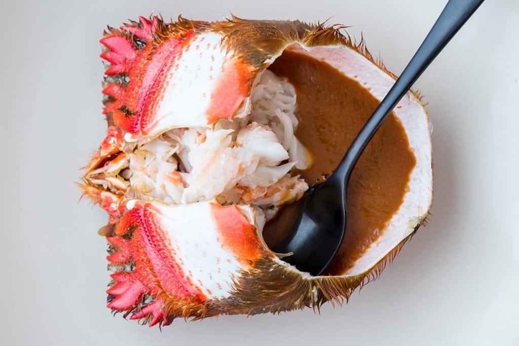 Spanner crabmeat, shredded and served in a sauce made from its roe inside its own shell, at Saint Peter restaurant in Sydney. Photo: Nikki To