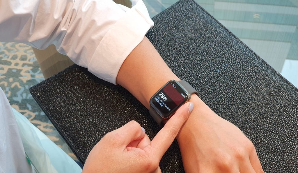 A user taking an EKG by placing her finger on the crown of the Apple Watch Series 4. The test takes about 30 seconds.