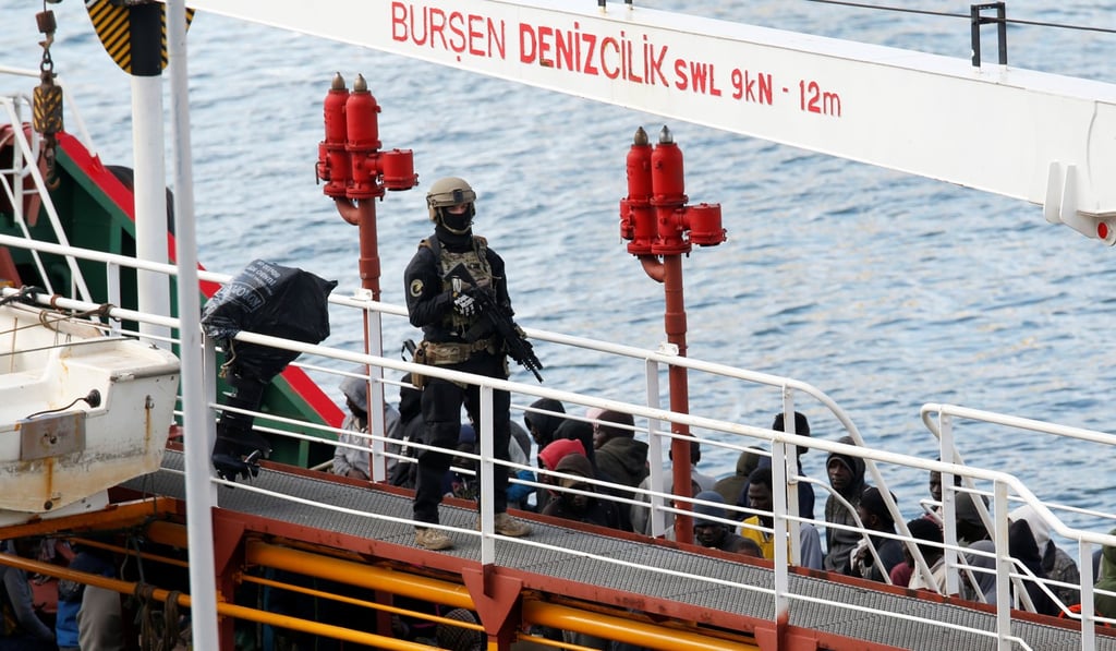 A Maltese special forces soldier guarding a group of migrants on the merchant ship Elhiblu 1 after it arrived in Senglea in Valletta’s Grand Harbour, Malta on March 28, 2019. Photo: Reuters