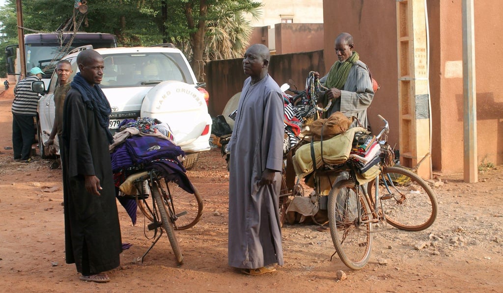 Three Fulani men sell traditional fabric on a road in Sevare, Mali. Photo: Reuters