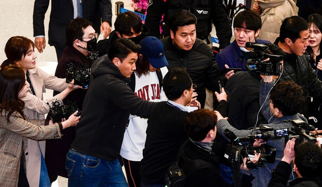 K-pop star Jung Joon-young (centre), pictured surrounded by reporters as he arrives at Incheon International Airport, has retired from show business after being questioned by police over claims that he secretly filmed himself having sex with women and then sharing the footage in an online chat room. Photo: AFP
