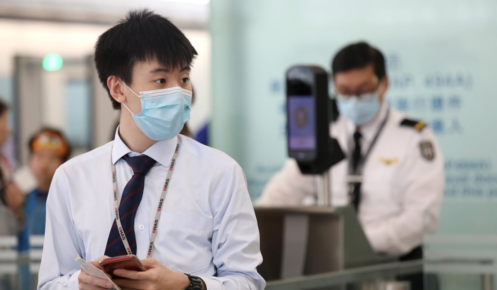 A member of staff at the airport wears a face mask amid an outbreak of measles. Photo: Dickson Lee