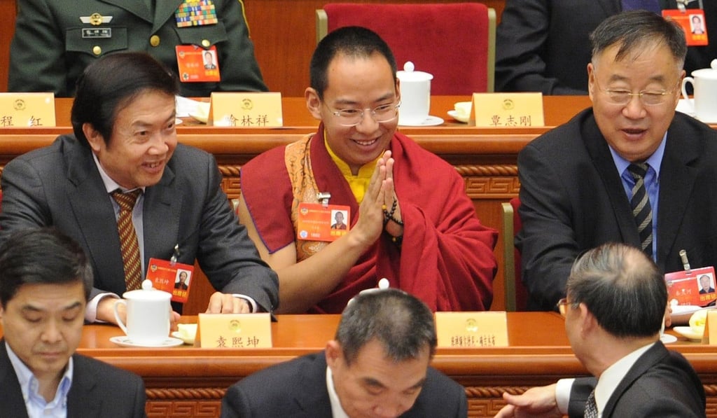 The 11th Panchen Lama, Gyaincain Norbu, pays his respects to a delegate before the opening session of the Chinese People's Political Consultative Conference in 2014. Photo: AFP