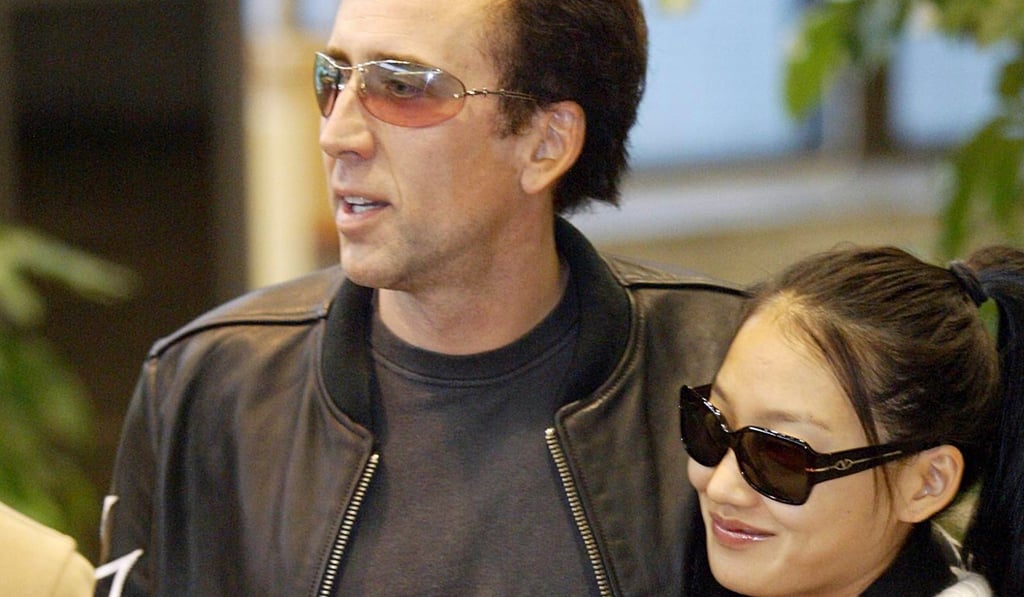 Nicolas Cage and his then wife Alice Kim arrive in Taiwan in 2004. Photo: AP