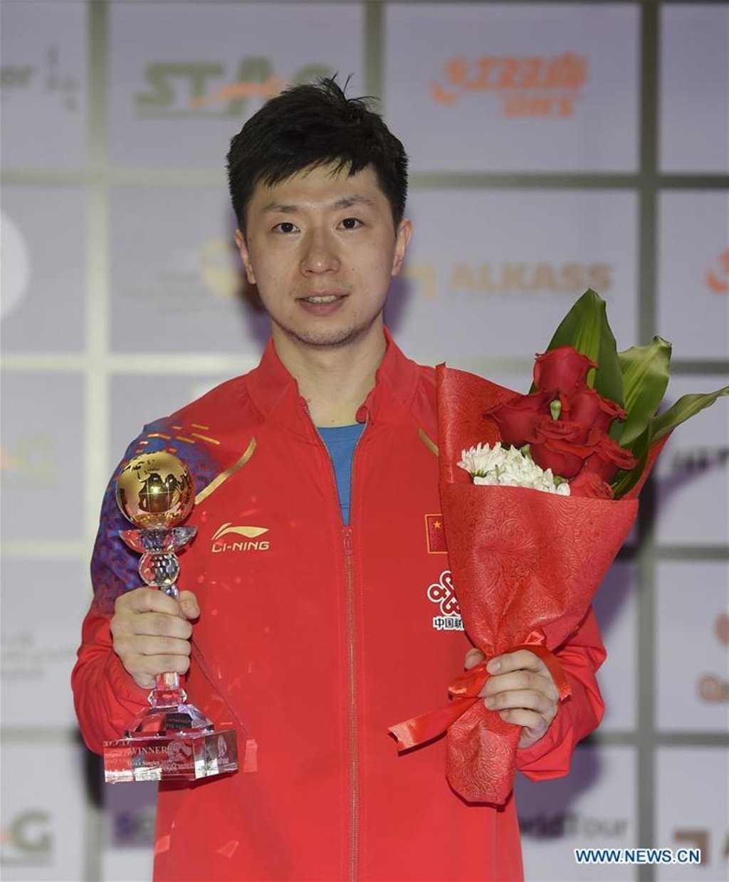 Ma Long with his trophy in Doha. Photo: Xinhua