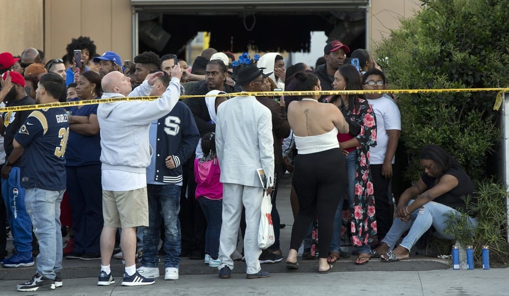 People gather near Hussle’s Marathon Clothing shop in Los Angeles on March 31, 2019. Photo: AP People gather near Hussle’s Marathon Clothing shop in Los Angeles on March 31, 2019. Photo: AP