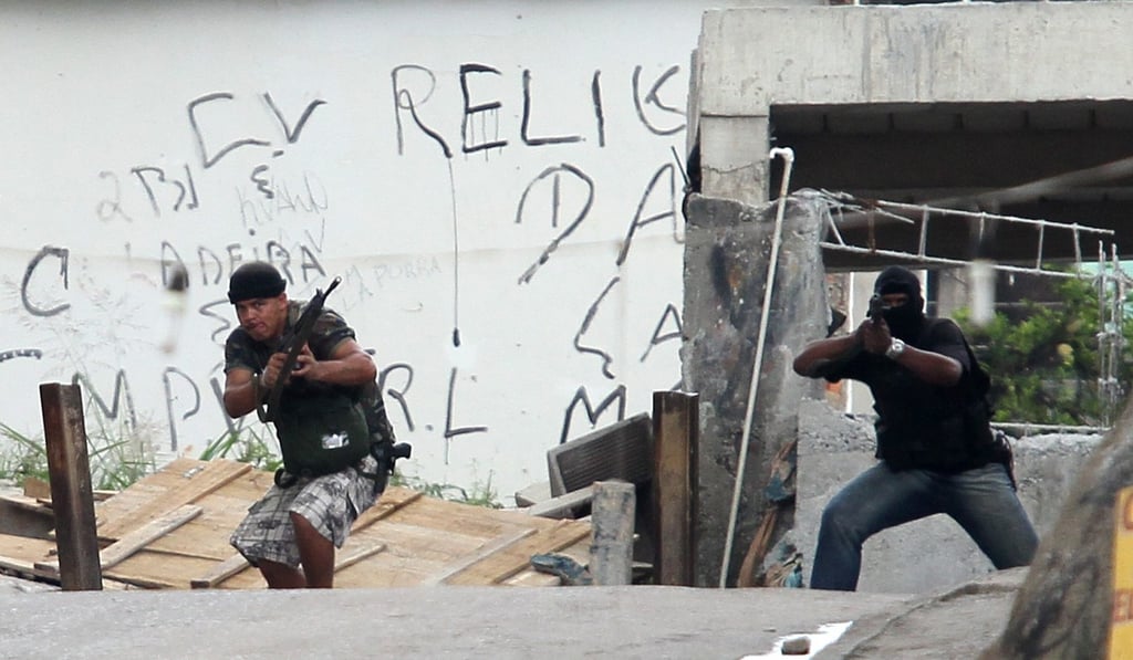 Armed suspected drug gang members take positions during an operation at Grota slum in Rio de Janeiro. File photo: Reuters