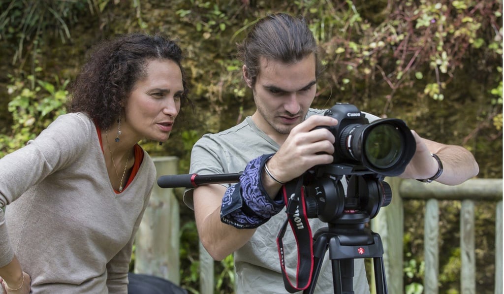 Bedos filming with a volunteer. Bedos filming with a volunteer.
