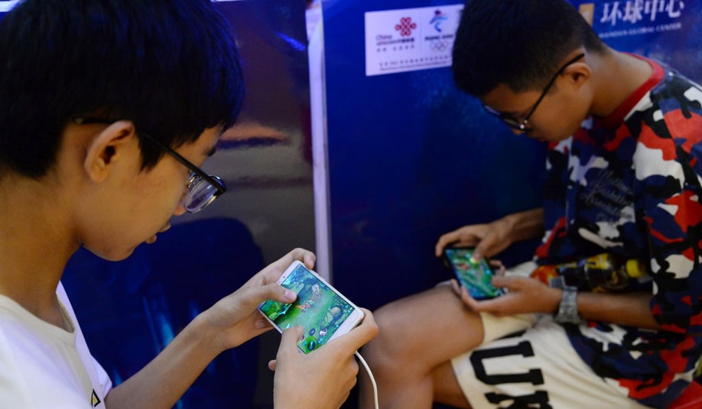 Young boys play Tencent’s Honour of Kings video game. Photo: Reuters
