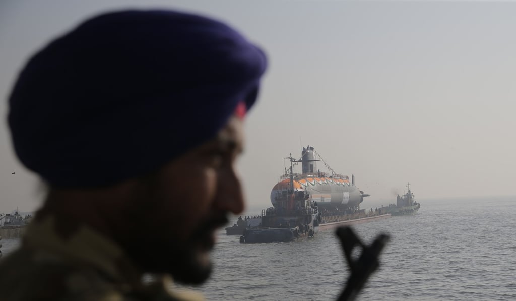 A security guard looks on as an Indian submarine is launched in January 2018. Photo: AP