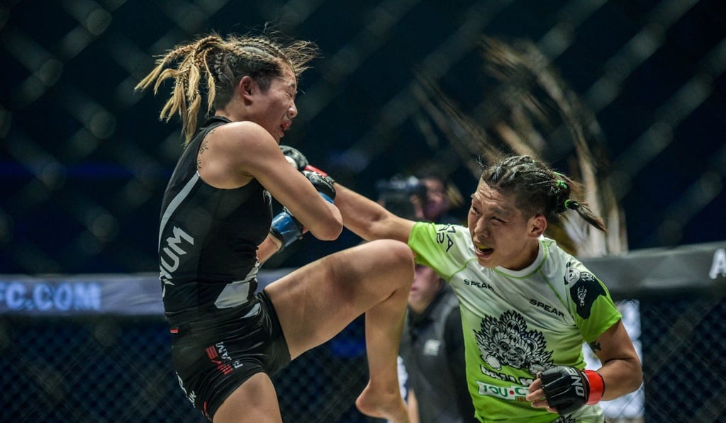 China’s Xiong Jingnan throws a right against Angela Lee. China’s Xiong Jingnan throws a right against Angela Lee.