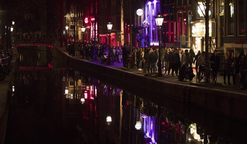 Tourists walking through Amsterdam’s red light district. Photo: AP
