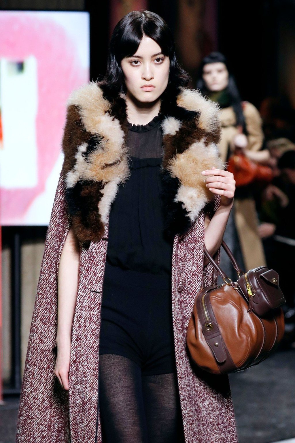 Miu Miu made the trend more wearable by attaching a small bag to a larger one. Photo: AFP