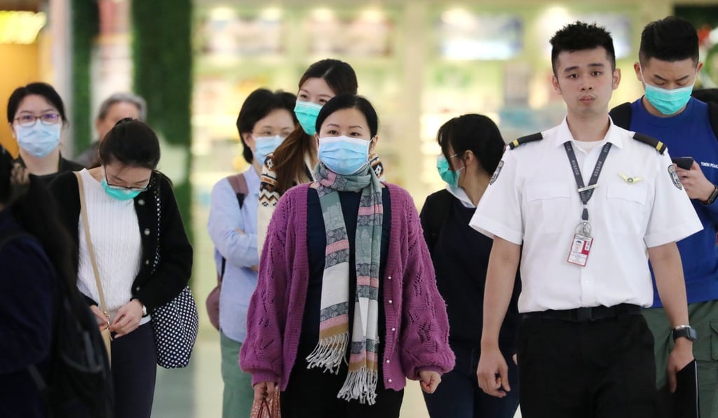 Travellers arrive at Hong Kong International Airport with their faces partially covered to guard against infection during the measles outbreak in the city. Photo: Felix Wong