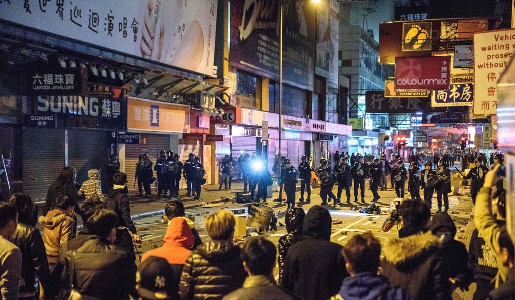 Men who burned cardboard and threw bottles at police during Mong Kok ...