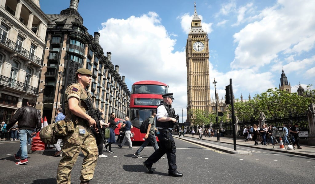 A soldier and an armed police officer patrol near the Houses of Parliament in May, 2017. Photo: Bloomberg