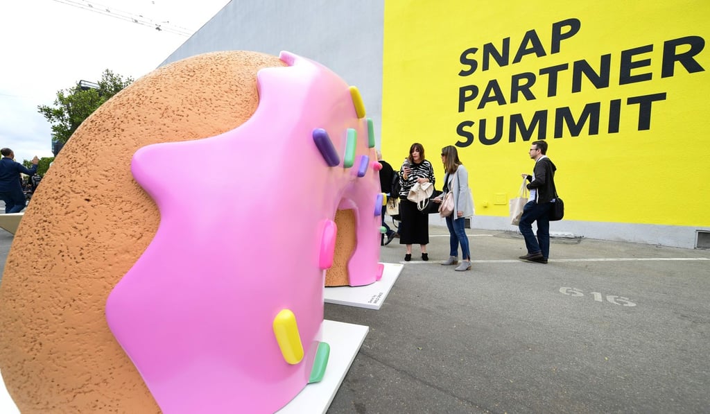 People walk past a sculpture of Snap’s AR lenses ‘donut’ at the first annual Snap Partner Summit in West Hollywood, California. Photo: AFP People walk past a sculpture of Snap’s AR lenses ‘donut’ at the first annual Snap Partner Summit in West Hollywood, California. Photo: AFP