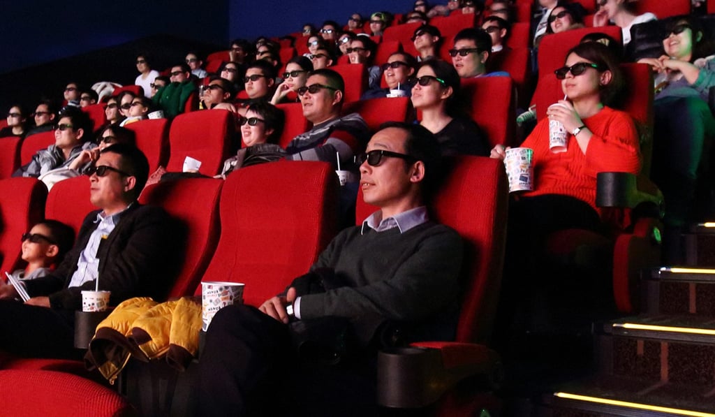 People wear 3-D glasses while watching a film in a theatre owned by Wanda Cinema Line, operated by Dalian Wanda Group. Photo: Bloomberg