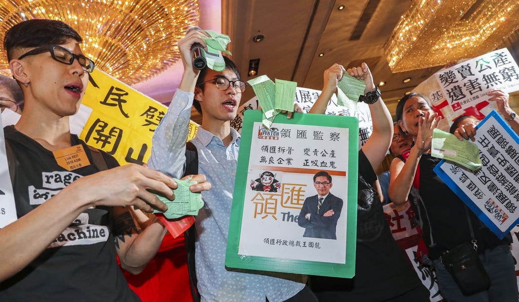 Members of the Link Watch concern group urge the government to buy back the Link Reit’s properties, during the company’s annual general meeting in Tsim Sha Tsui in July 2018. Photo: K.Y. Cheng