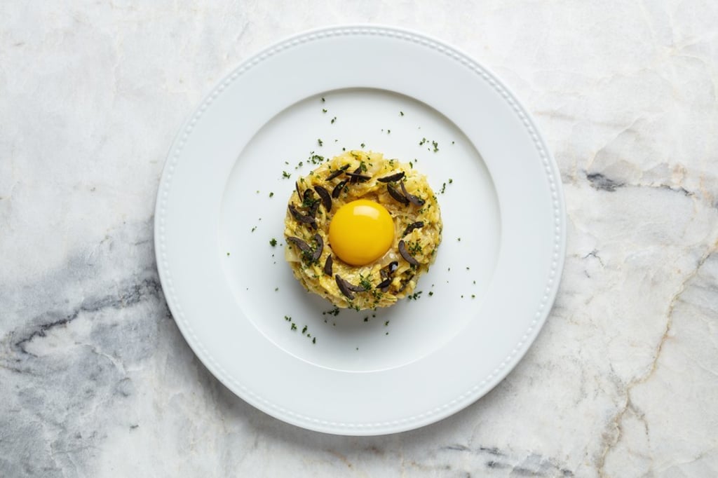 Salted cod à Brás with slow cooked egg yolk and onion purée at Chiado