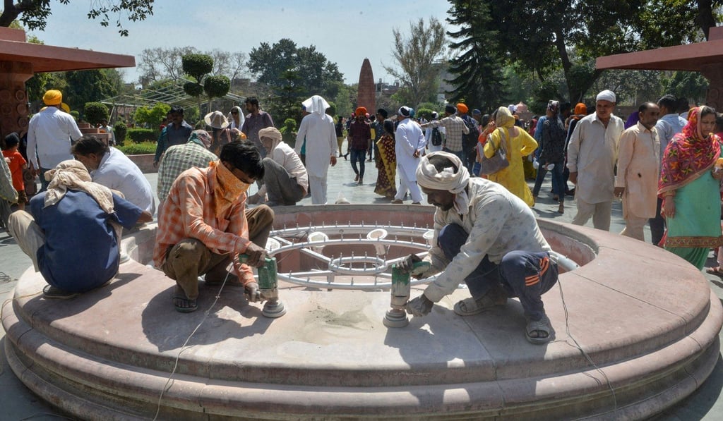 Indian workers polish marble near the Jallianwala Bagh Martyrs' Memorial. Photo: AFP
