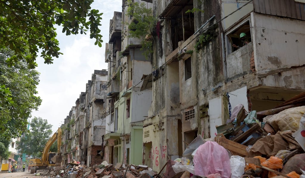 A Cambodian worker (R) looks through a window during demolition work at the White Building residential complex in Phnom Penh. Photo: AFP A Cambodian worker (R) looks through a window during demolition work at the White Building residential complex in Phnom Penh. Photo: AFP