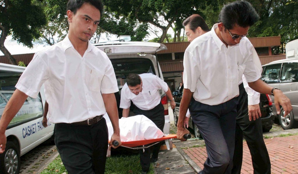 Undertakers carry the body of a prisoner executed in Singapore. Photo: EPA