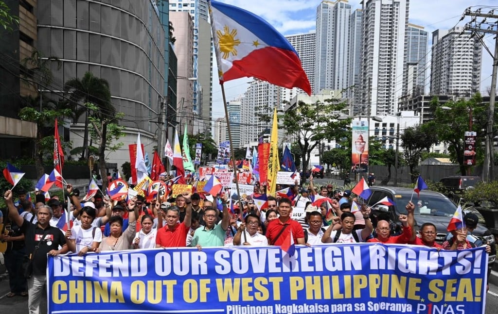 Protesters carrying national flags and placards in Manila. Photo: AFP