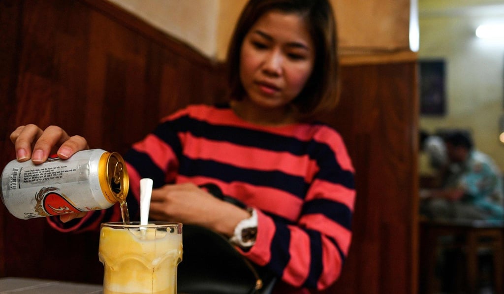 Malaysian tourist ST Lim drinks egg beer at the Giang Cafe in Hanoi. Photo: Manan Vatsyayana/AFP Malaysian tourist ST Lim drinks egg beer at the Giang Cafe in Hanoi. Photo: Manan Vatsyayana/AFP