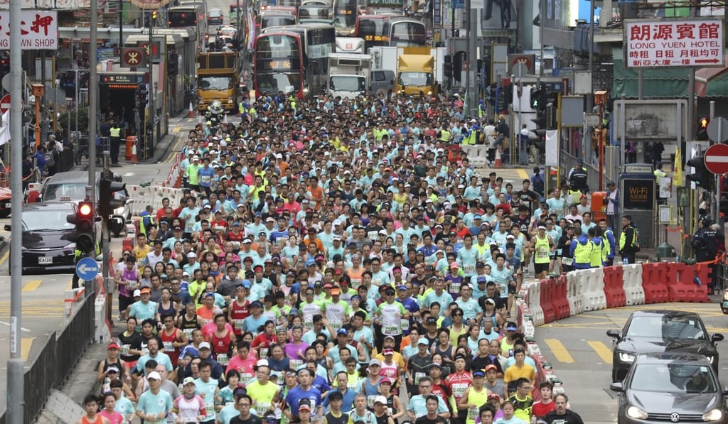 Participants run through Nathan Road in Mong Kok during the Standard Chartered Hong Kong Marathon. Photo: Dickson Lee