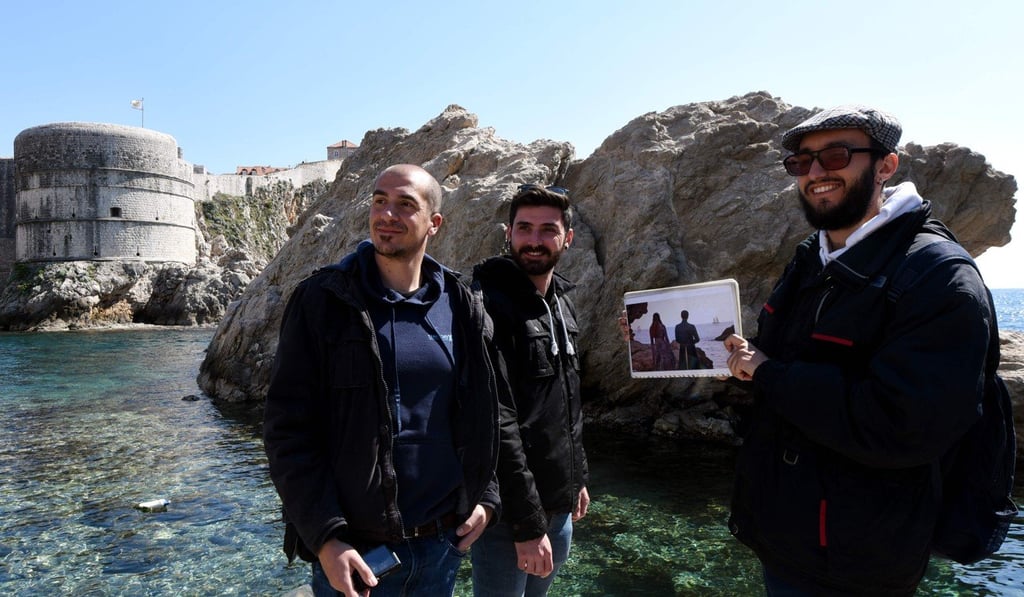 A tourist holds a picture of a Game of Thrones scene for fans from Spain during a guided tour of Dubrovnik. Photo: AFP