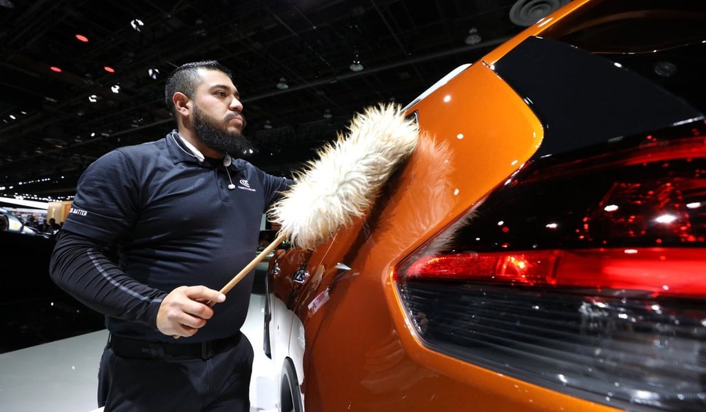 A worker dusts a Nissan Rogue at the North American International Auto Show in Detroit, Michigan in January 2019. Photo: Reuters