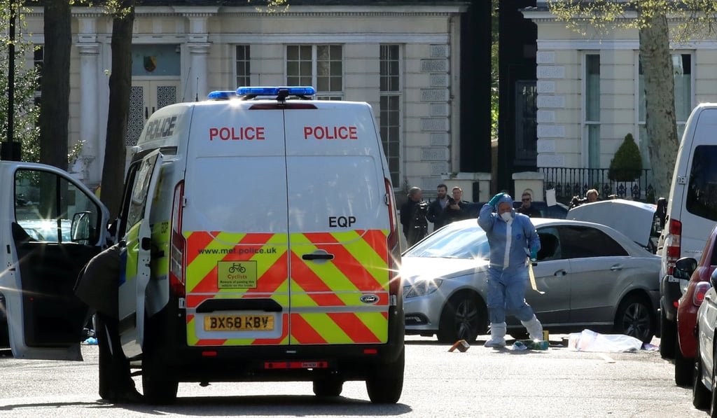 A police forensics officer works at the site where a car rammed the parked vehicle of the Ukrainian ambassador to the UK in London on Saturday. Photo: Reuters