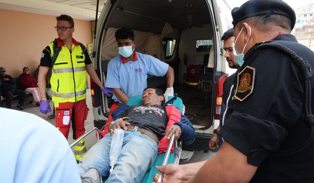 Medical staff take one of the plane crash victims to Grande International Hospital, in Kathmandu. Photo: AFP