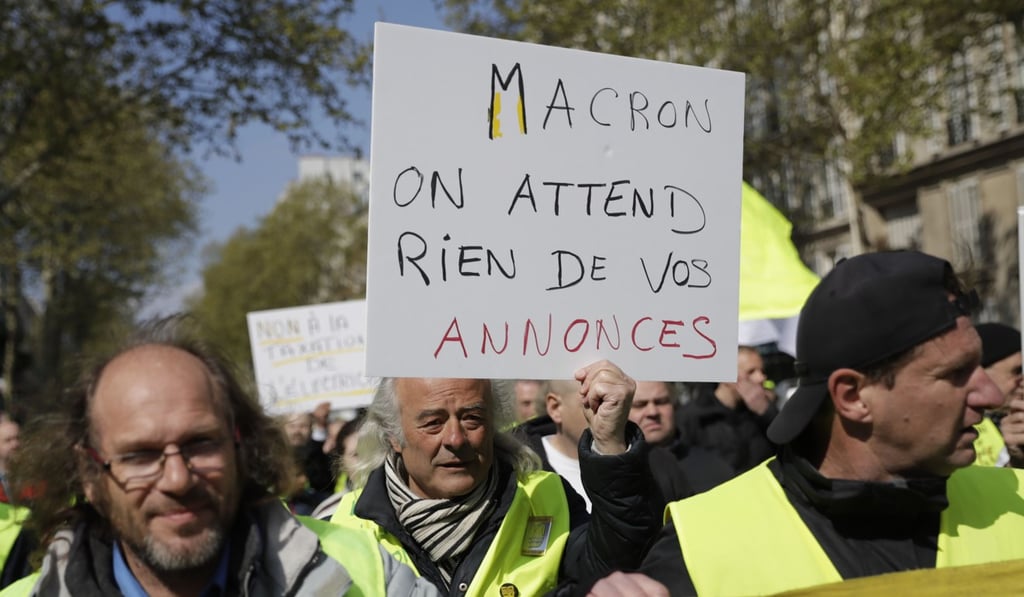 A demonstrator holds a banner reading “French President Macron, we don't expect anything from your announcements” on April 13. Photo: AFP A demonstrator holds a banner reading “French President Macron, we don't expect anything from your announcements” on April 13. Photo: AFP