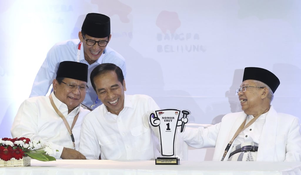 Prabowo, seated left, and Widodo, second from left, share a light moment with their running mates Sandiaga Uno, top, and Maruf Amin, right, in September. Photo: AP Prabowo, seated left, and Widodo, second from left, share a light moment with their running mates Sandiaga Uno, top, and Maruf Amin, right, in September. Photo: AP