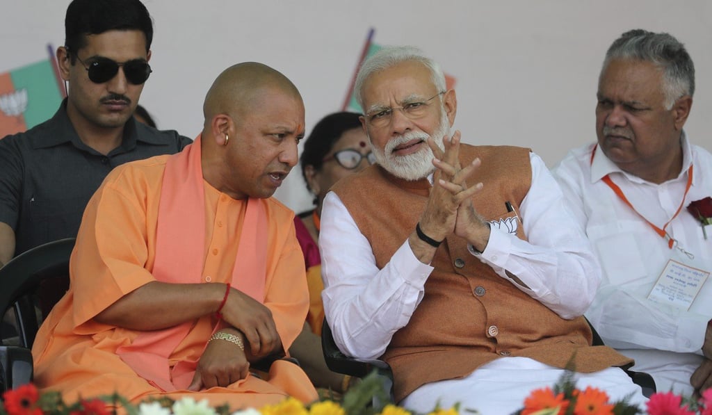 Chief Minister of Uttar Pradesh state Yogi Adityanath speaks with Indian Prime Minister Narendra Modi. Photo: AP