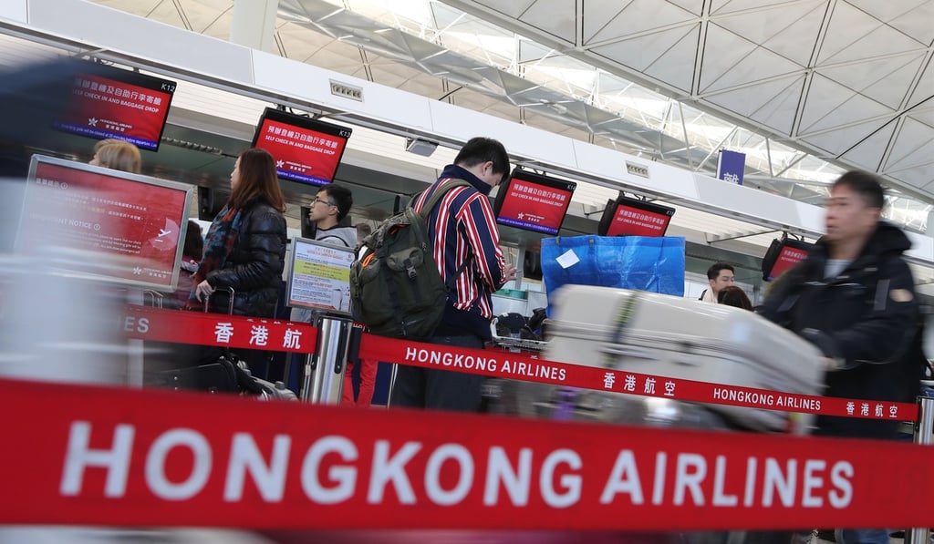 Passengers wait in line at Hong Kong Airlines counters at the airport. Photo: K.Y. Cheng