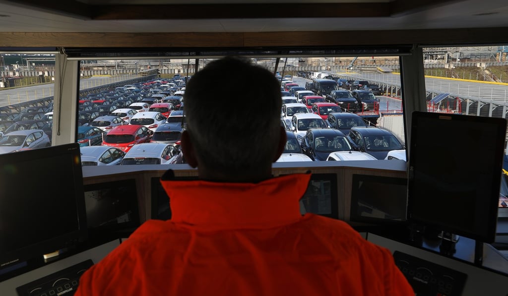 A skipper stands on the bridge overlooking Ford cars on the deck of a barge on the River Rhine in Cologne, Germany, on February 13. Ford earlier this year announced thousands of job cuts across Europe, and warned that measures in the event of a no-deal Brexit would be significantly more dramatic. Photo: Bloomberg