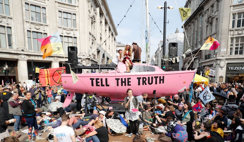 Climate change activists listen to speeches at their encampment blocking the road junction at Oxford Circus. Photo: AFP Climate change activists listen to speeches at their encampment blocking the road junction at Oxford Circus. Photo: AFP